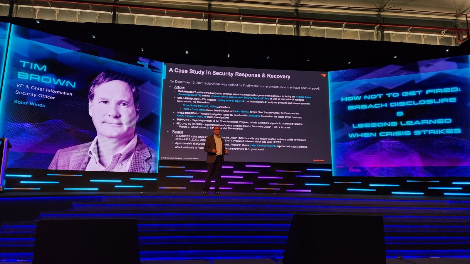 Tim Brown presenting on stage at a major security conference